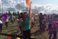 Angela throwing colors at the Festival of Colors.